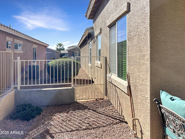 view of property exterior featuring fence and stucco siding