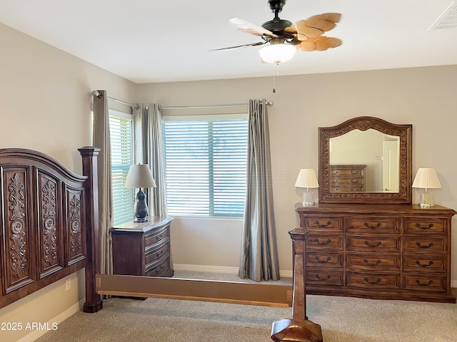 carpeted bedroom featuring a ceiling fan, visible vents, and baseboards