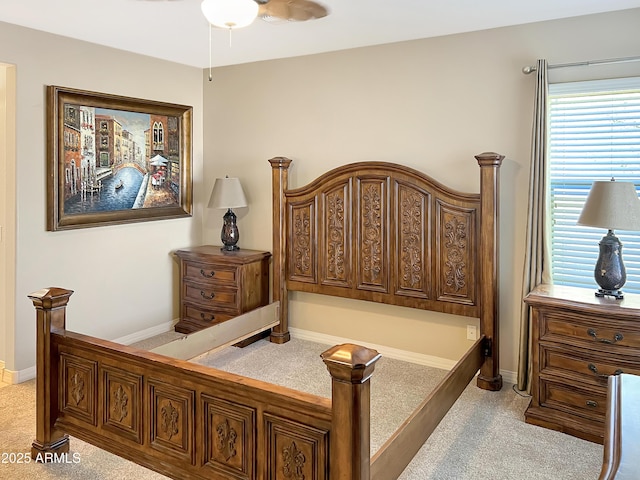 bedroom with baseboards and light colored carpet