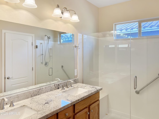 full bath with double vanity, a sink, and a shower stall