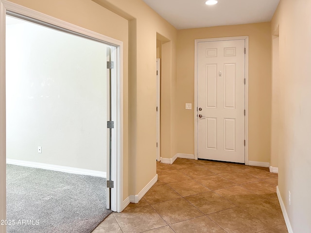 hallway with light tile patterned floors, baseboards, and recessed lighting