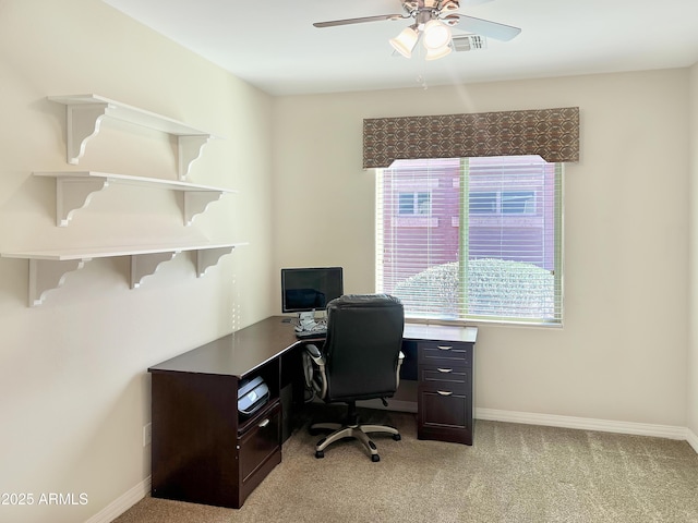 home office with light colored carpet, visible vents, ceiling fan, and baseboards