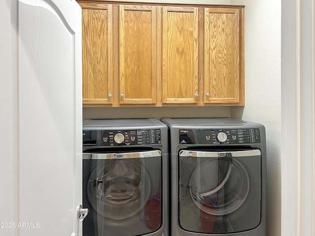 laundry room featuring cabinet space and washer and clothes dryer