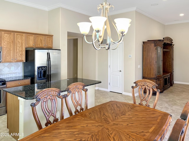 dining space featuring light tile patterned floors, baseboards, a chandelier, and crown molding