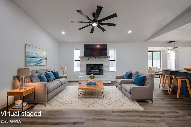 619 N Norfolk, Mesa, AZ 85205 - living area with wood finished floors, a ceiling fan, lofted ceiling, a brick fireplace, and recessed lighting