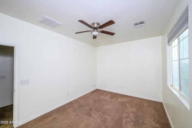 carpeted spare room featuring ceiling fan