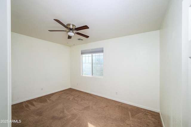 empty room featuring carpet flooring and ceiling fan