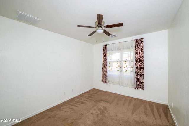 carpeted spare room featuring ceiling fan