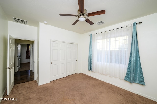 unfurnished bedroom featuring ceiling fan, carpet floors, and a closet