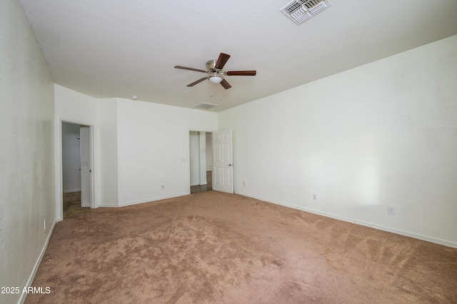 carpeted spare room with ceiling fan