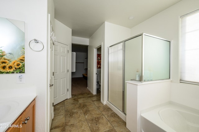 bathroom featuring vanity and plus walk in shower