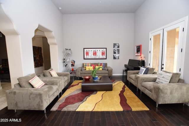 9842 E Celtic Dr, Scottsdale, AZ 85260 - living room featuring a towering ceiling, wood finished floors, and arched walkways