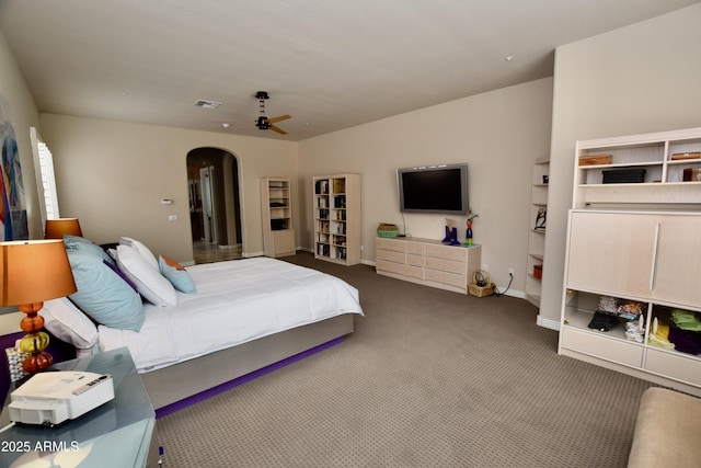 9842 E Celtic Dr, Scottsdale, AZ 85260 - carpeted bedroom with arched walkways, baseboards, and ceiling fan