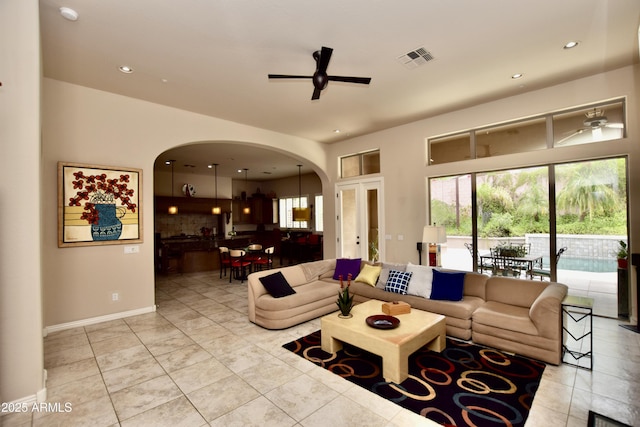 9842 E Celtic Dr, Scottsdale, AZ 85260 - living area featuring arched walkways, ceiling fan, recessed lighting, and baseboards