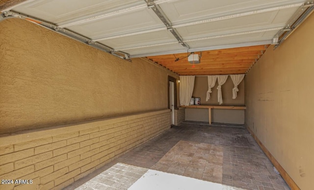 5850 W Cheery Lynn Rd, Phoenix, AZ 85031 - garage featuring baseboards and a garage door opener