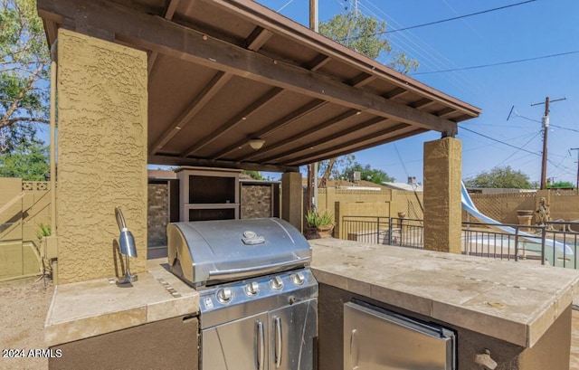 5850 W Cheery Lynn Rd, Phoenix, AZ 85031 - view of patio / terrace featuring exterior kitchen, a fenced backyard, and area for grilling