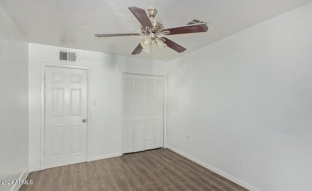 unfurnished bedroom with ceiling fan and dark hardwood / wood-style flooring