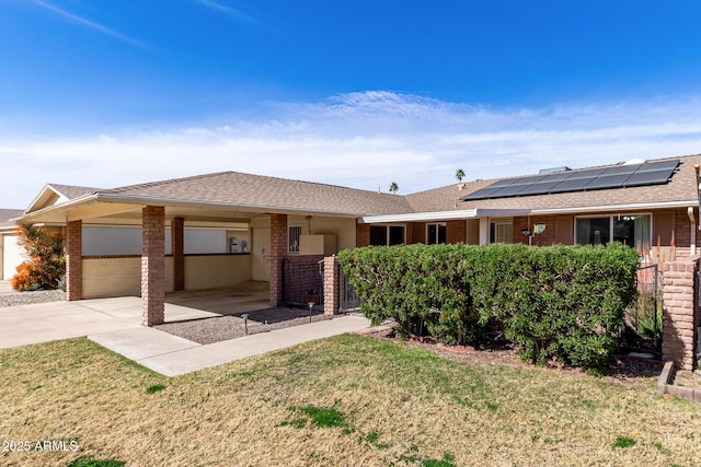 single story home with brick siding, an attached garage, concrete driveway, and a front yard