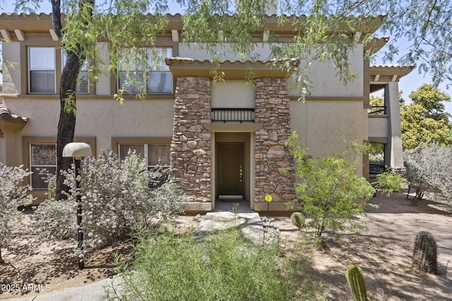 19700 N 76th St Unit 1103, Scottsdale, AZ 85255 - view of front of house featuring stucco siding and stone siding