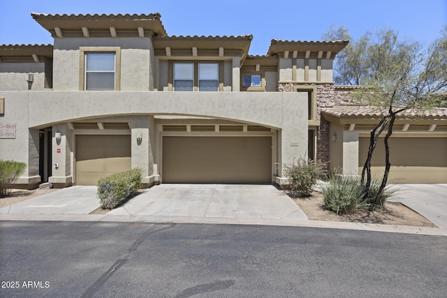 19700 N 76th St Unit 1103, Scottsdale, AZ 85255 - view of front facade featuring stucco siding, a tiled roof, driveway, and a garage