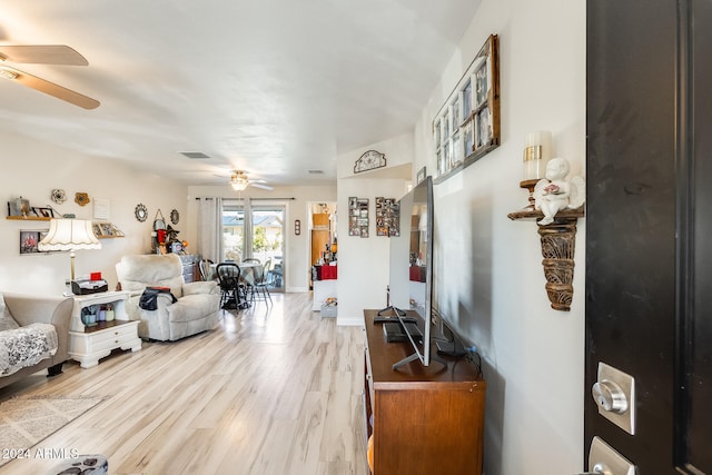 living room featuring hardwood / wood-style floors and ceiling fan