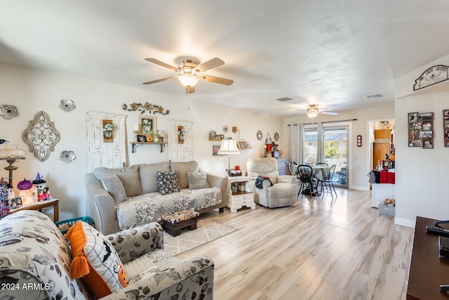 living room with ceiling fan and light wood-type flooring