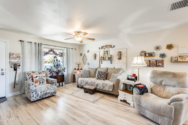 living room featuring ceiling fan and light wood-type flooring