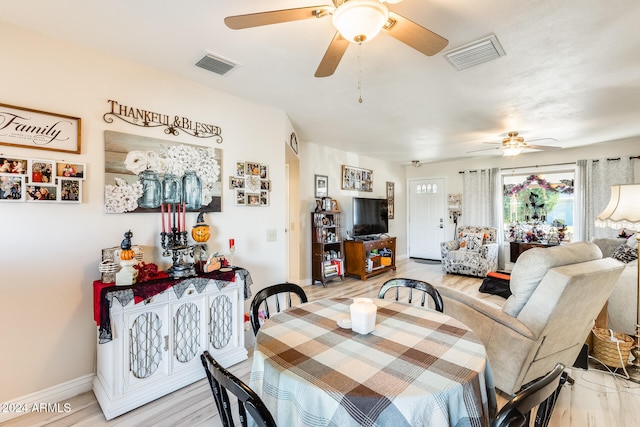 dining space with hardwood / wood-style flooring and ceiling fan