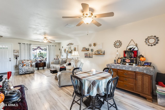 dining space with ceiling fan and light hardwood / wood-style flooring