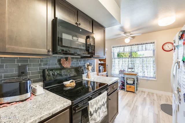 kitchen featuring black appliances, light stone countertops, dark brown cabinetry, light wood-type flooring, and tasteful backsplash