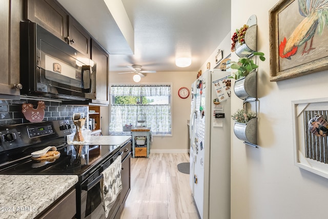 kitchen with dark brown cabinets, light stone countertops, white refrigerator with ice dispenser, stainless steel electric range oven, and tasteful backsplash