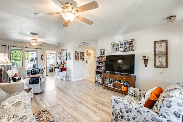 living room featuring light hardwood / wood-style floors and ceiling fan