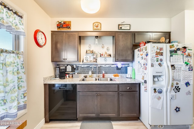 kitchen with white fridge with ice dispenser, sink, dishwasher, light hardwood / wood-style floors, and decorative backsplash