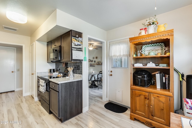 kitchen featuring black electric range, decorative backsplash, dark brown cabinetry, and light wood-type flooring