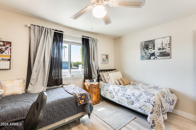 bedroom with light wood-type flooring and ceiling fan