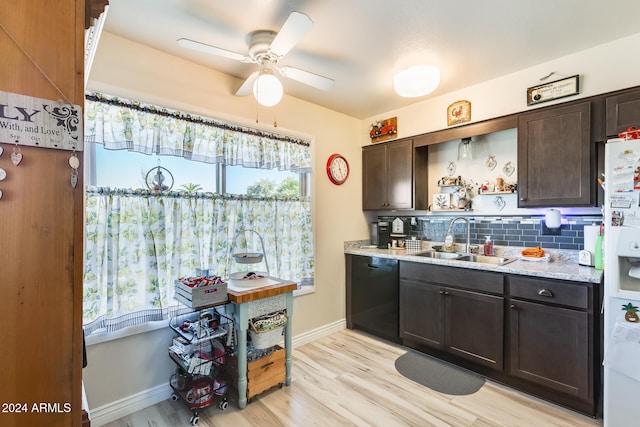 kitchen featuring dishwasher, white fridge with ice dispenser, backsplash, sink, and dark brown cabinetry