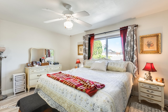 bedroom with light hardwood / wood-style floors and ceiling fan