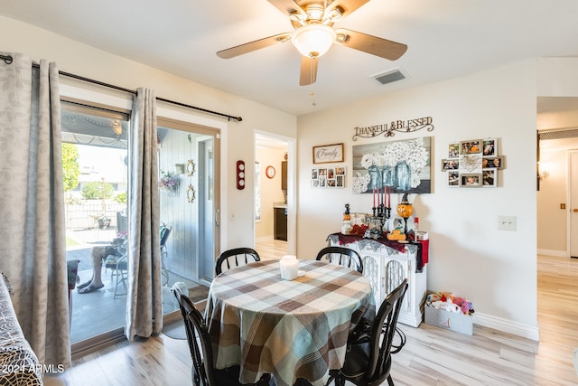 dining space with light wood-type flooring and ceiling fan