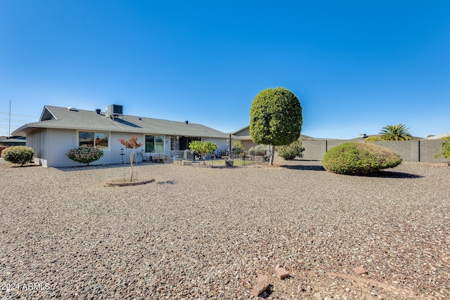 rear view of property with a patio area and central AC