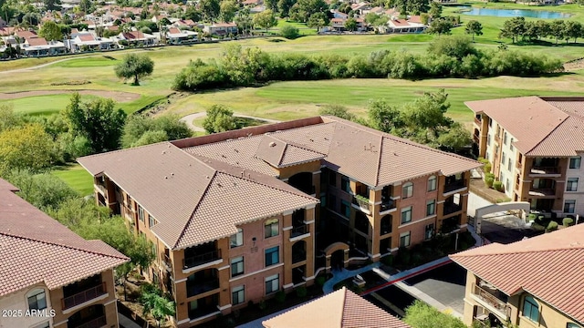 bird's eye view featuring view of golf course, a water view, and a residential view