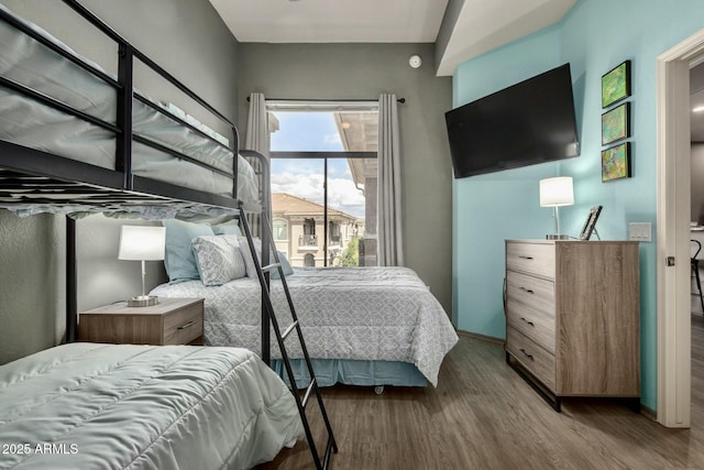 bedroom with baseboards and wood finished floors