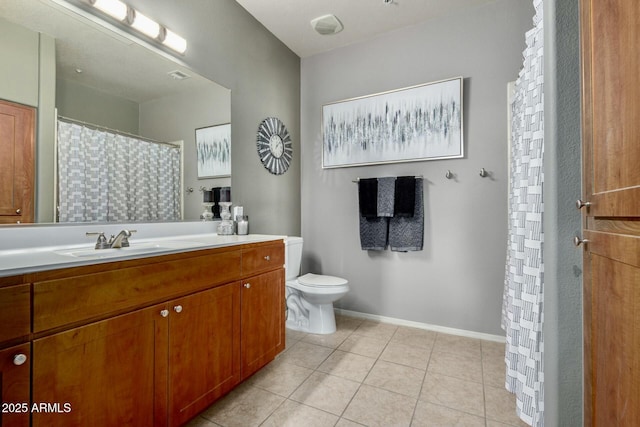 bathroom featuring tile patterned flooring, toilet, visible vents, vanity, and baseboards