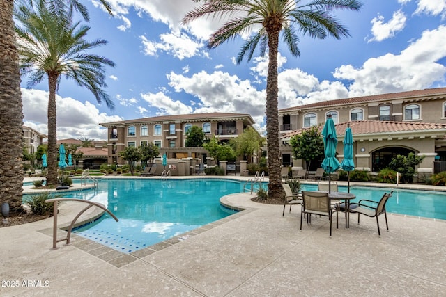 community pool with a patio area