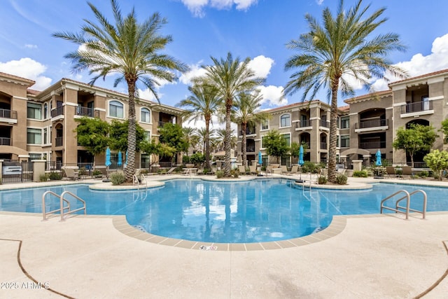 pool featuring fence and a patio