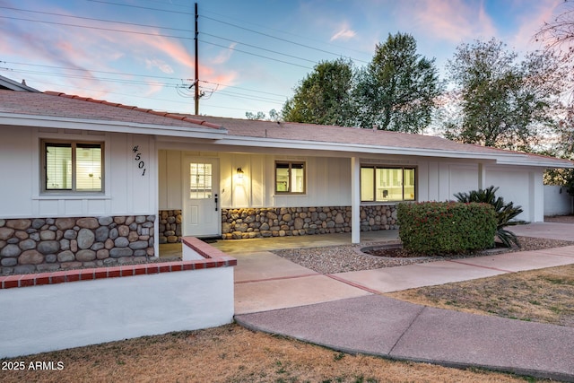 single story home featuring a garage and covered porch