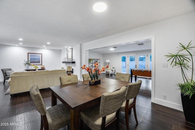 dining room with dark hardwood / wood-style flooring and french doors