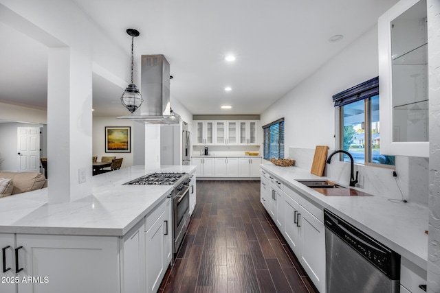 kitchen featuring sink, hanging light fixtures, island exhaust hood, stainless steel appliances, and white cabinets