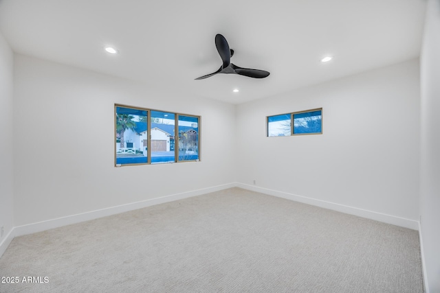 carpeted empty room featuring ceiling fan