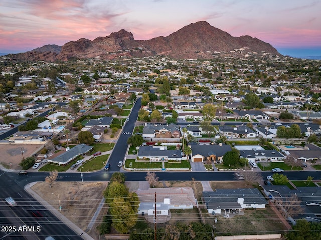 aerial view at dusk featuring a mountain view