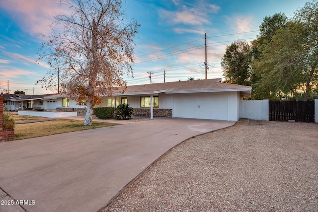 single story home with a garage and a lawn